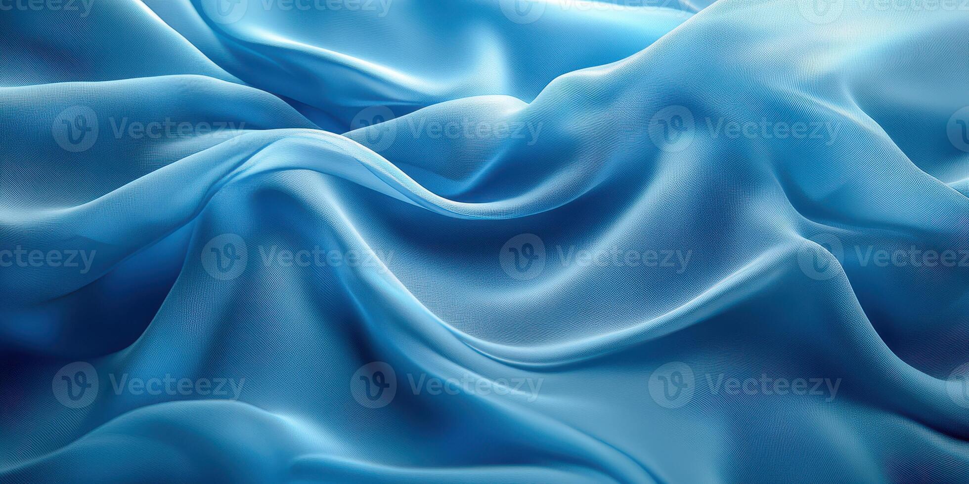 Elegant blue silk fabric with gentle folds creating a smooth texture shown in soft natural light during the day photo