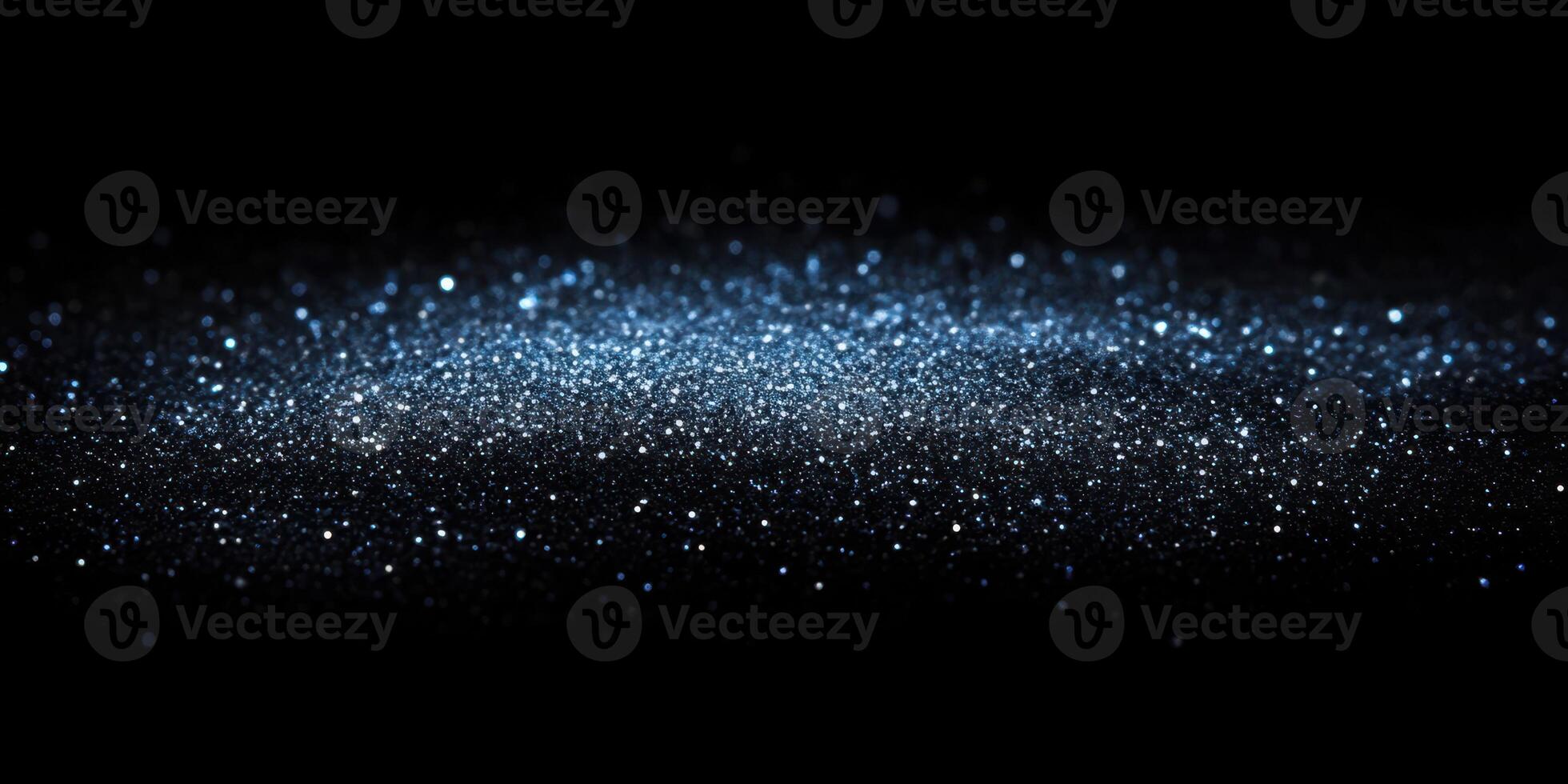 Sparkling blue particles against a black background create a mesmerizing visual effect during nighttime photo