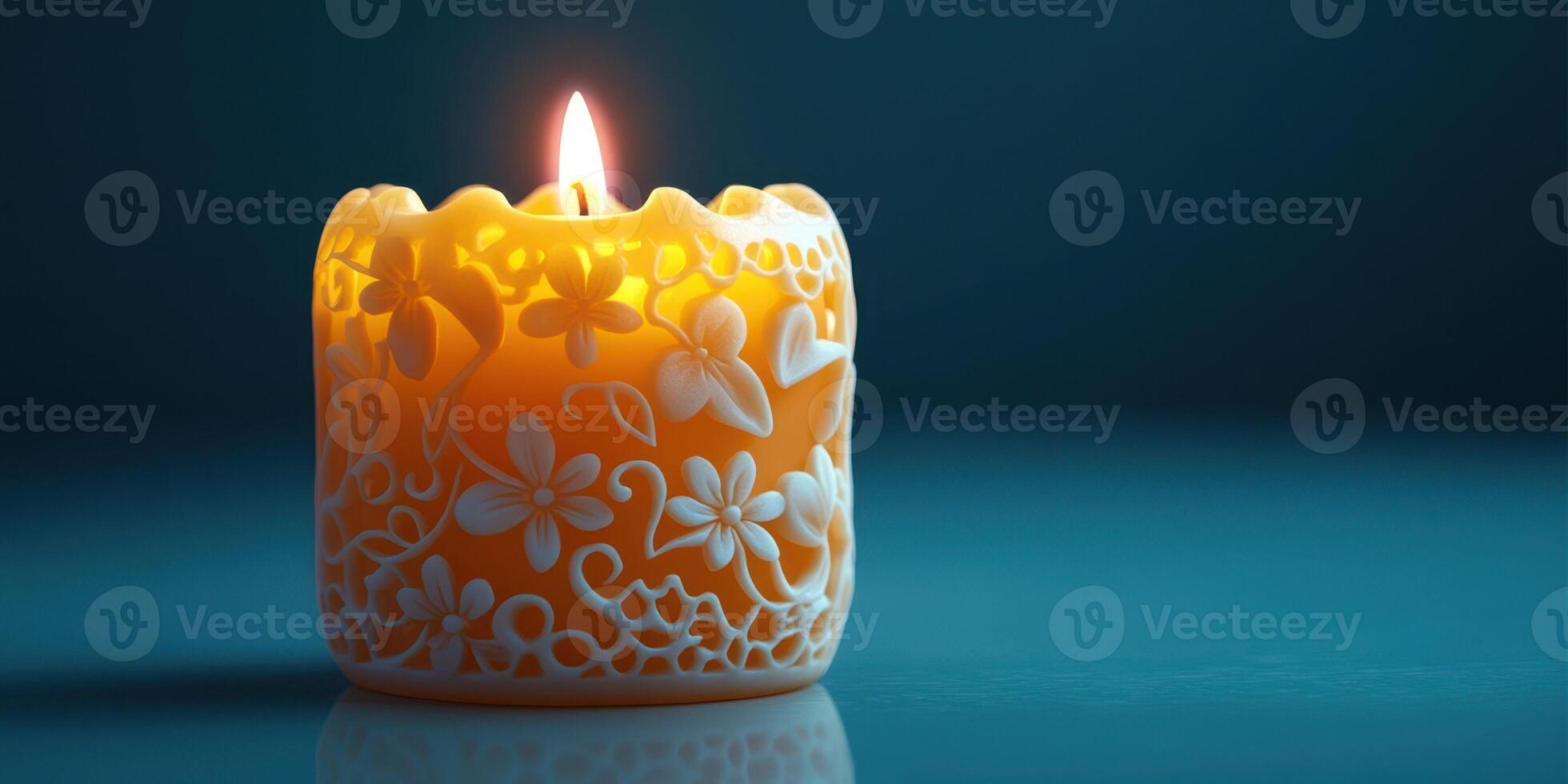 Intricately carved candle glowing softly in a dark blue setting photo