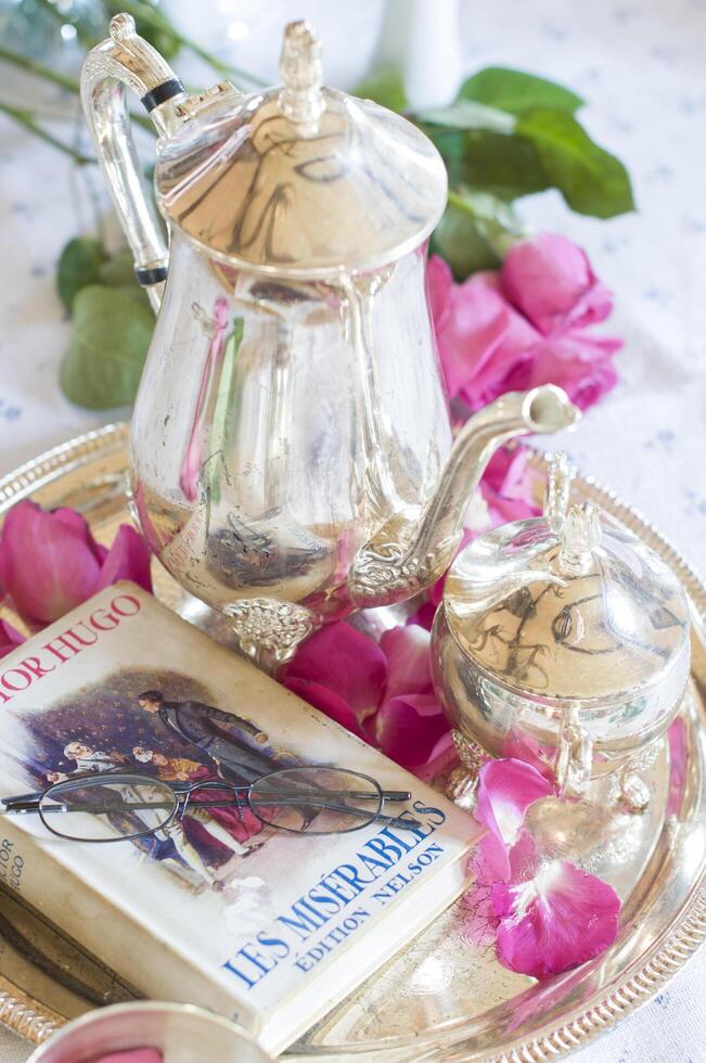 English retro still life,coffee with milk in elegant Chinese porcelain cup,light and airy mood of early morning before Christmas and favorite book in French on table As, Belgium, January 6,2020, photo