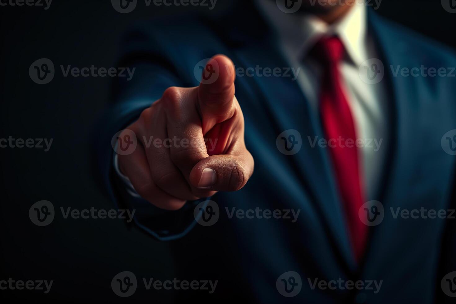 A man in a suit pointing at something photo