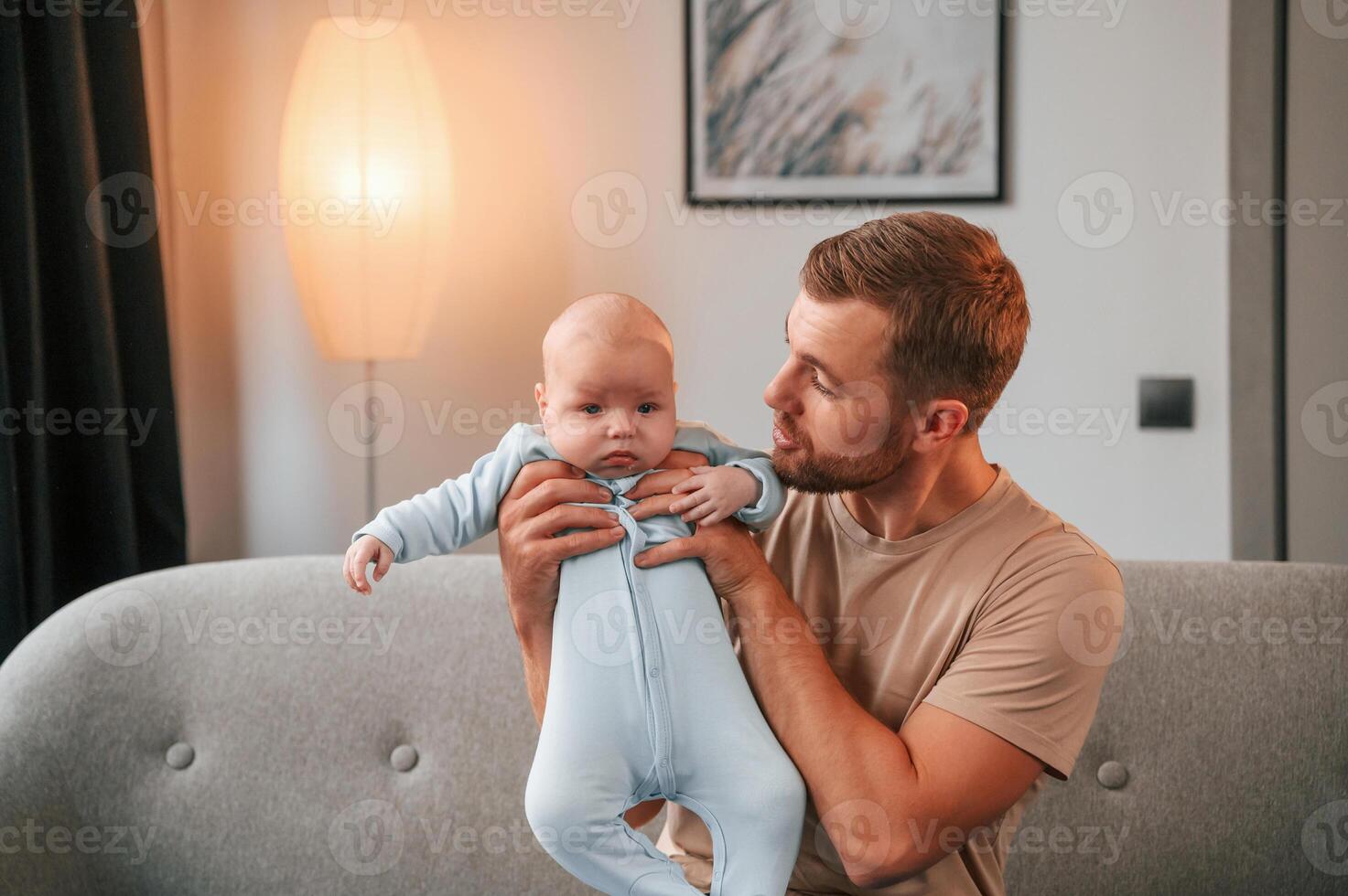 Father with his newborn baby is indoors. Conception of single dad photo