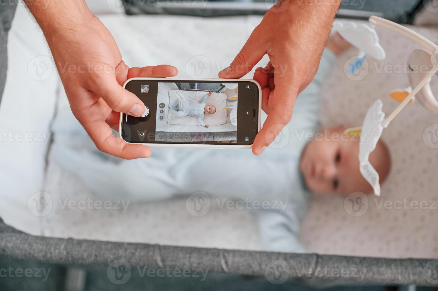 Taking, picture by, smartphone. Father with his newborn baby is indoors. Conception of single dad photo