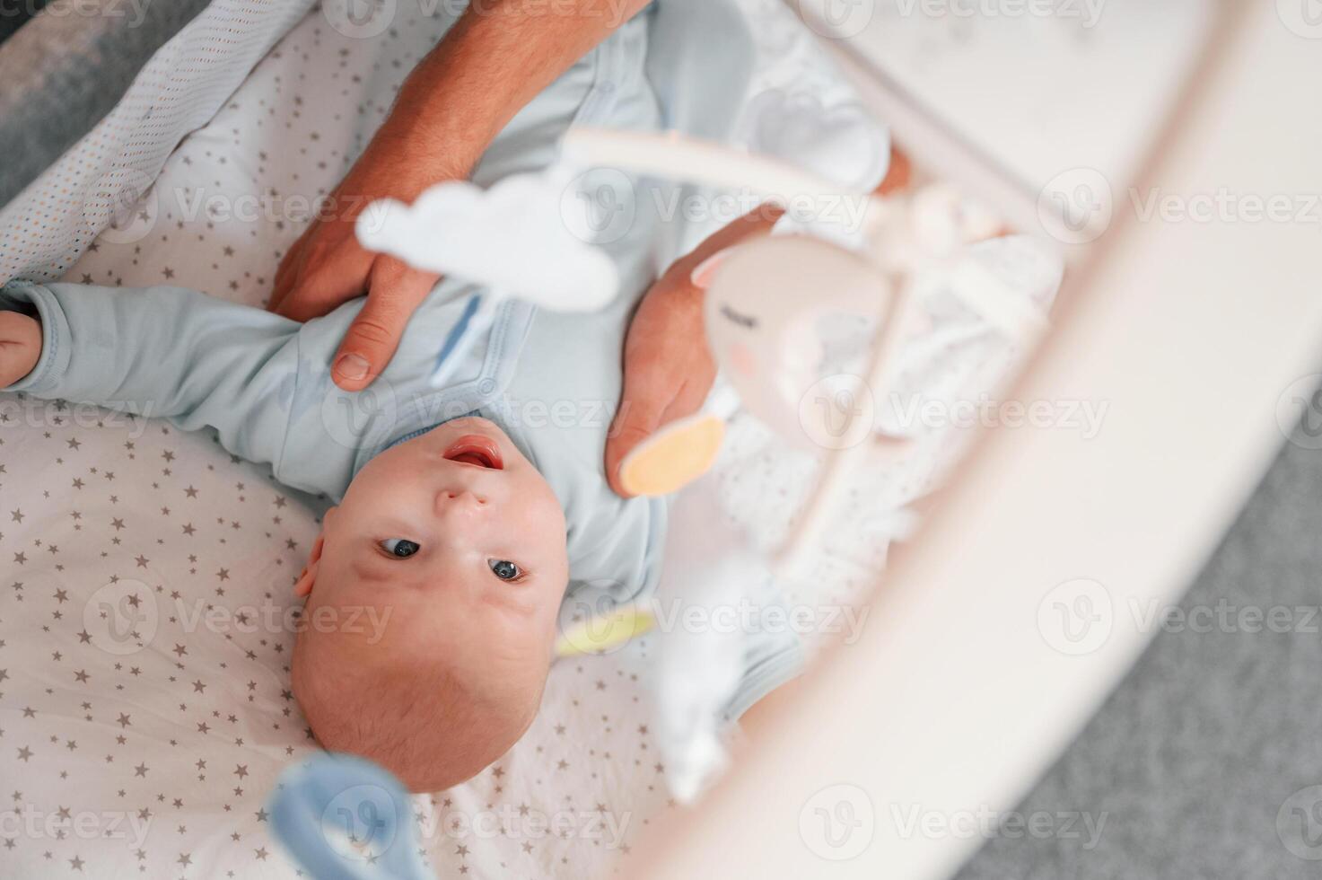 Top ,view of newborn baby that is lying down in the cradle photo