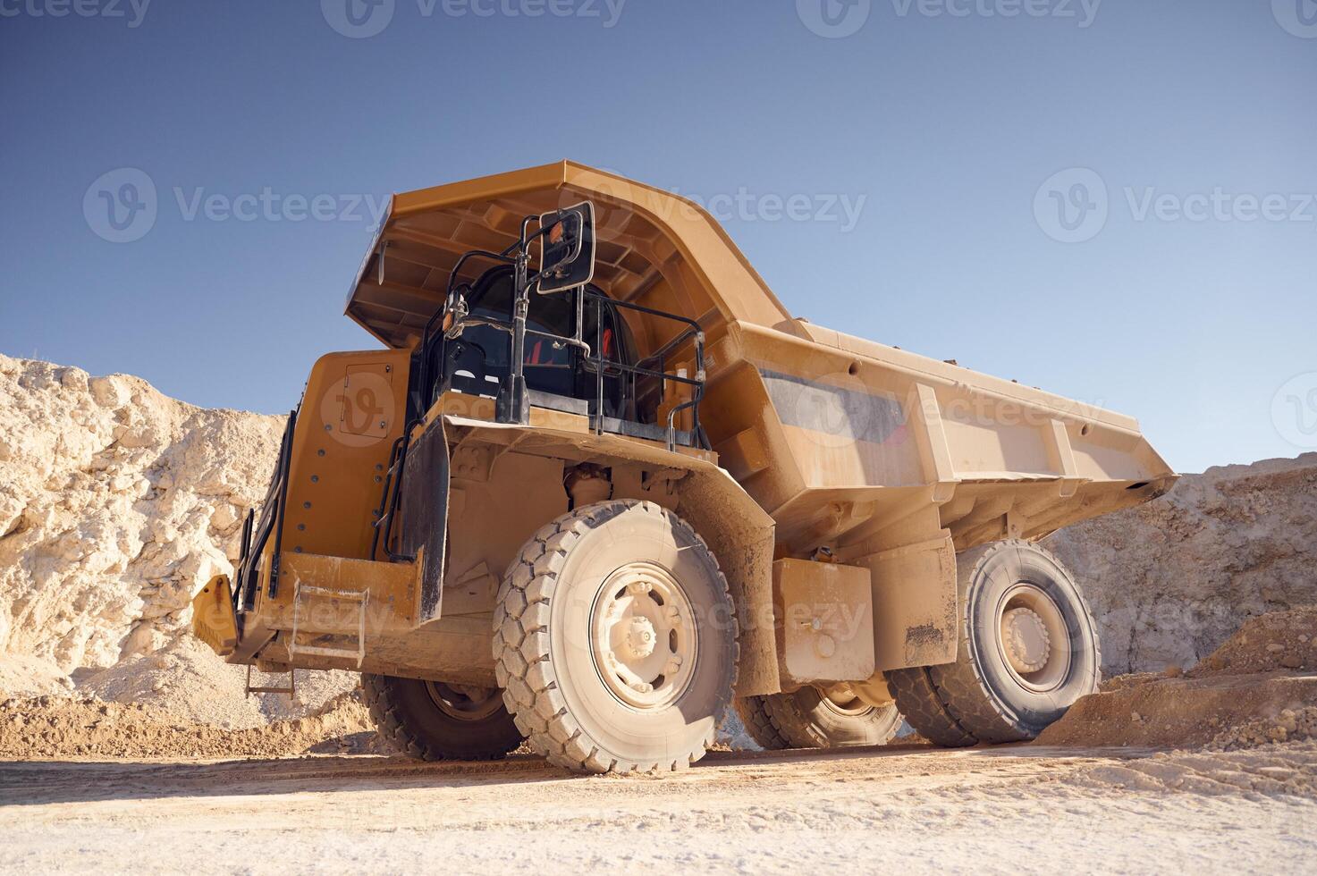 View from below of haul truck ,that is parked in the quarry at sunny daytime photo