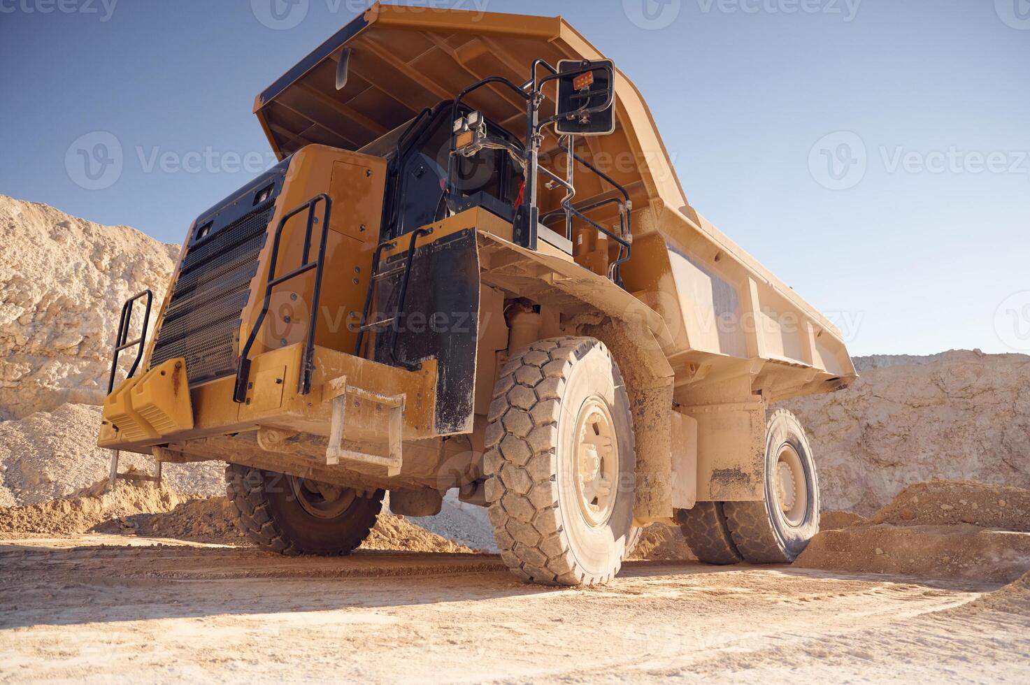View from below ,of haul truck that is parked in the quarry at sunny daytime photo