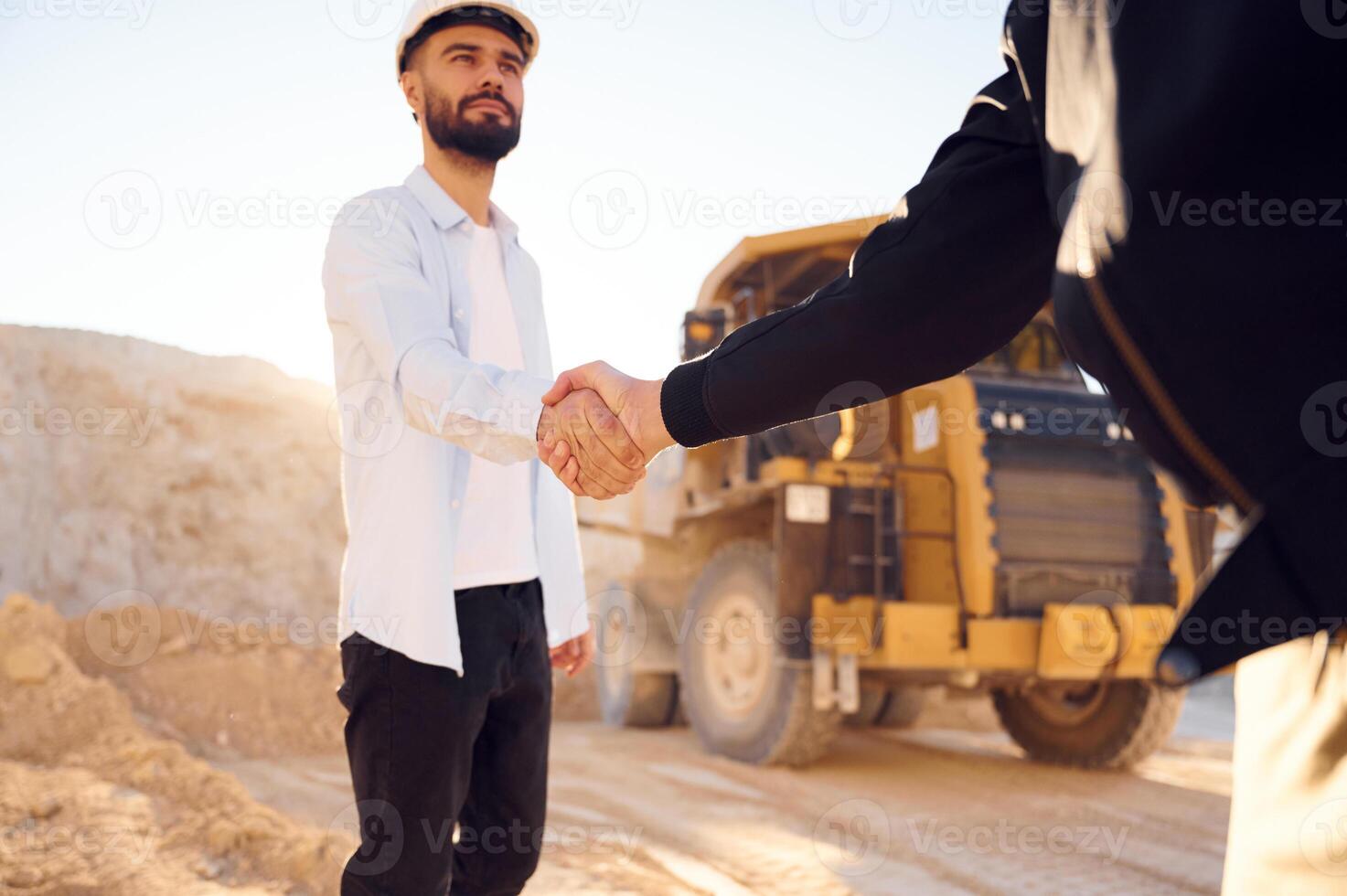 Quarry worker making a, deal with colleague. Shaking hands photo