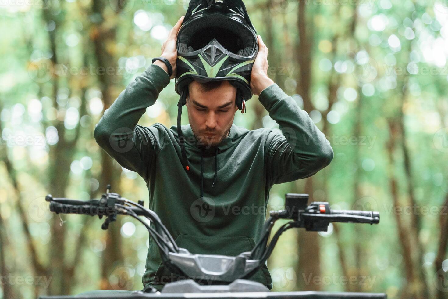With, safety helmet. TV driver is in the forest, having a ride at daytime photo