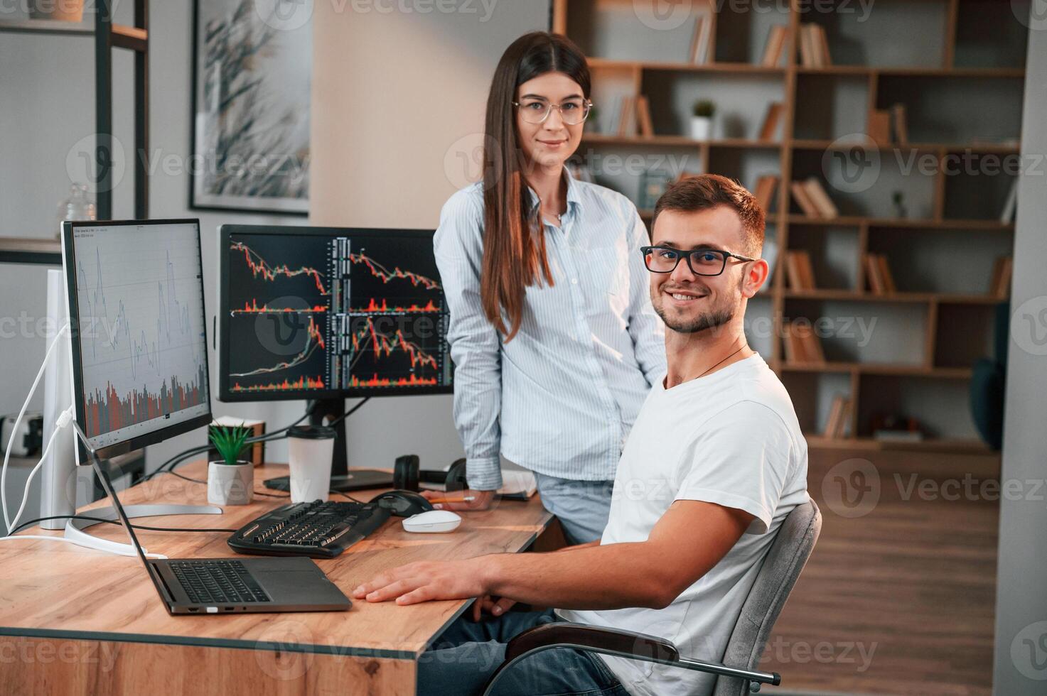 Two stock brokers is working together in the office with finances photo