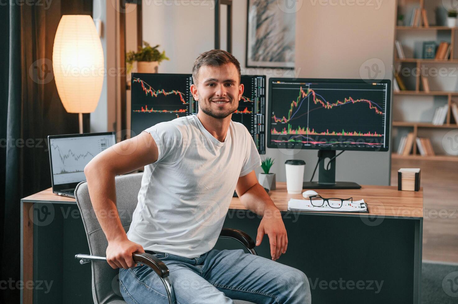 Young stock, broker is working in the office by using computer photo
