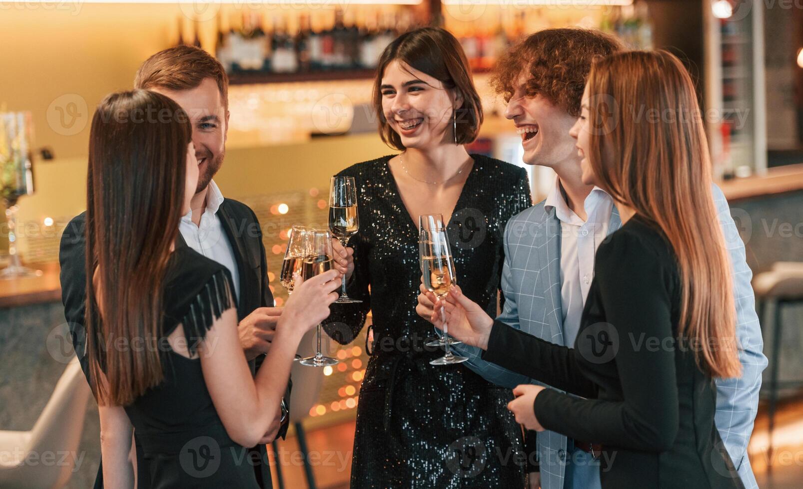 Conception of celebrating event. .Group of people in elegant clothes are in the restaurant photo