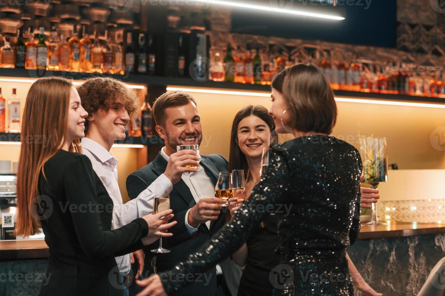 Friends are having, fun. Group of people in elegant clothes are in the restaurant celebrating event photo