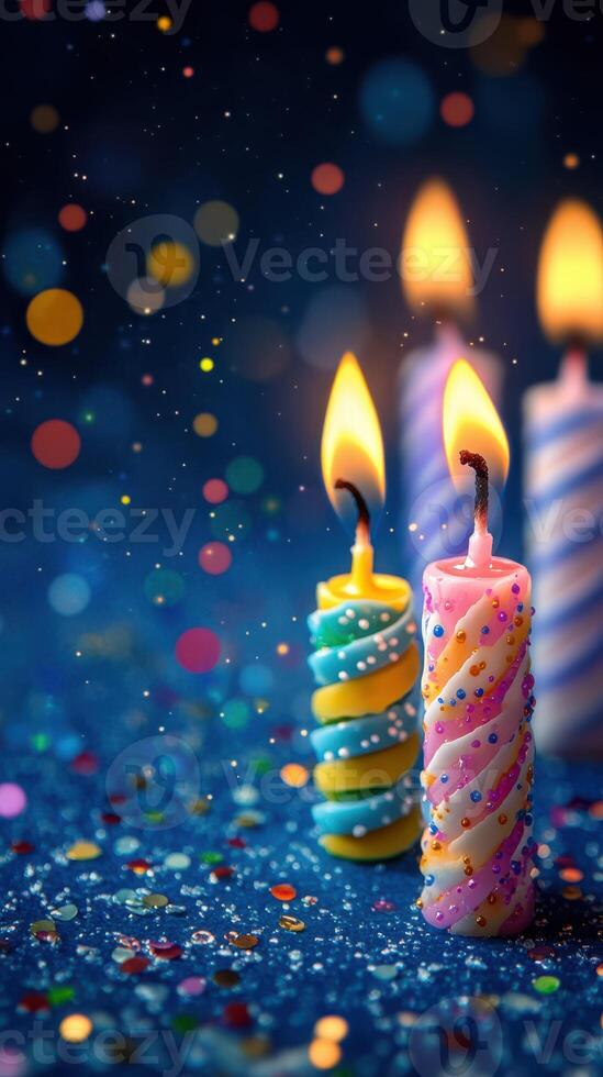Colorful birthday candles glowing softly on a festive table with sparkling confetti and vibrant decorations photo