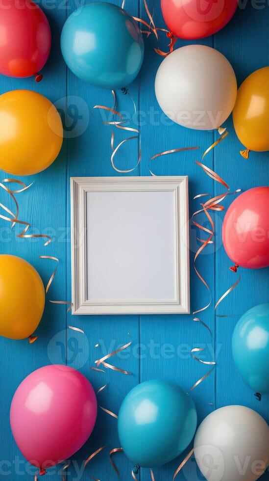 Colorful balloons surround an empty frame on a bright blue background, perfect for festive occasions or celebrations photo
