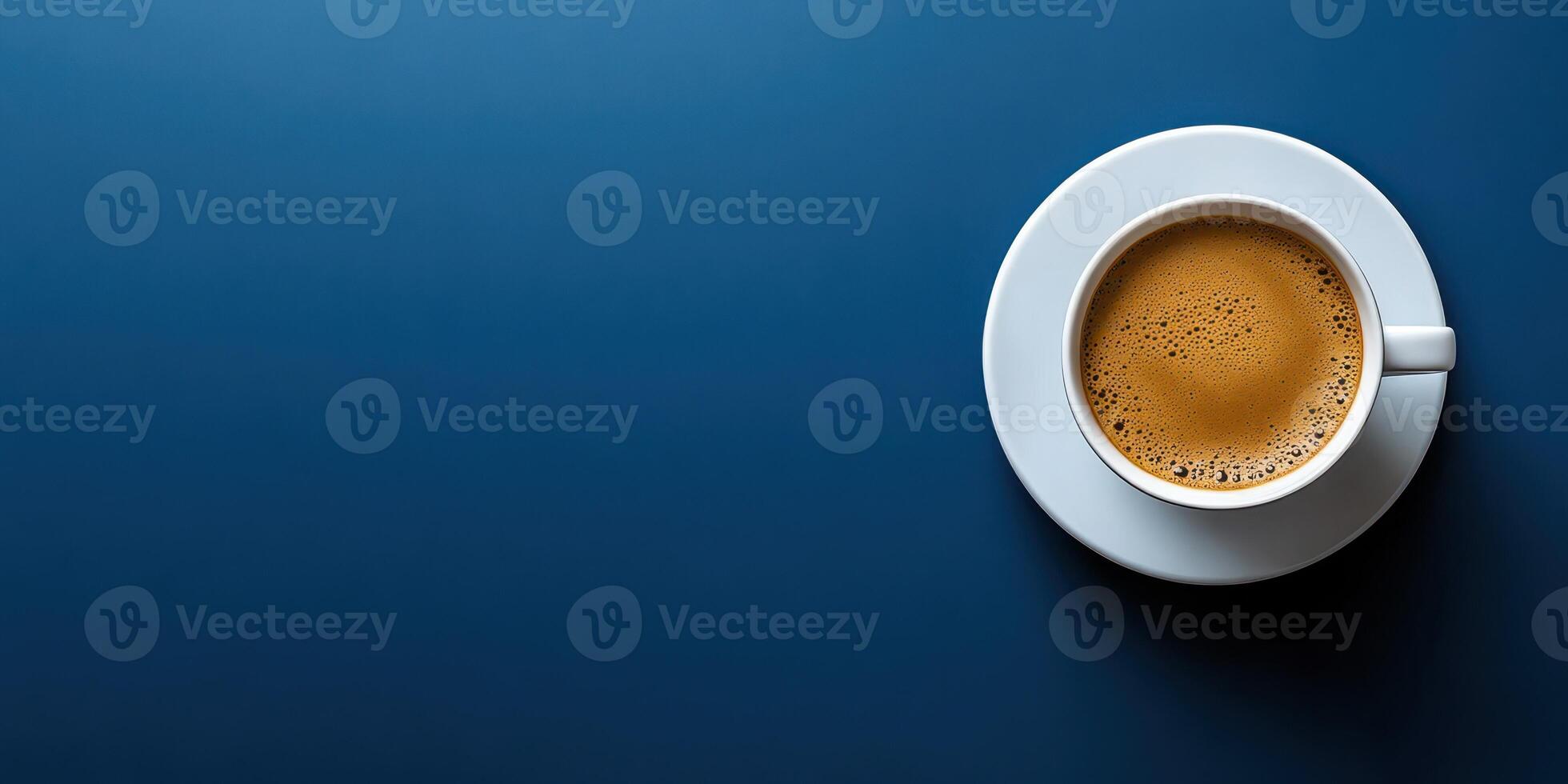 Freshly brewed coffee served in a white cup on a smooth blue table surface in a cozy setting photo
