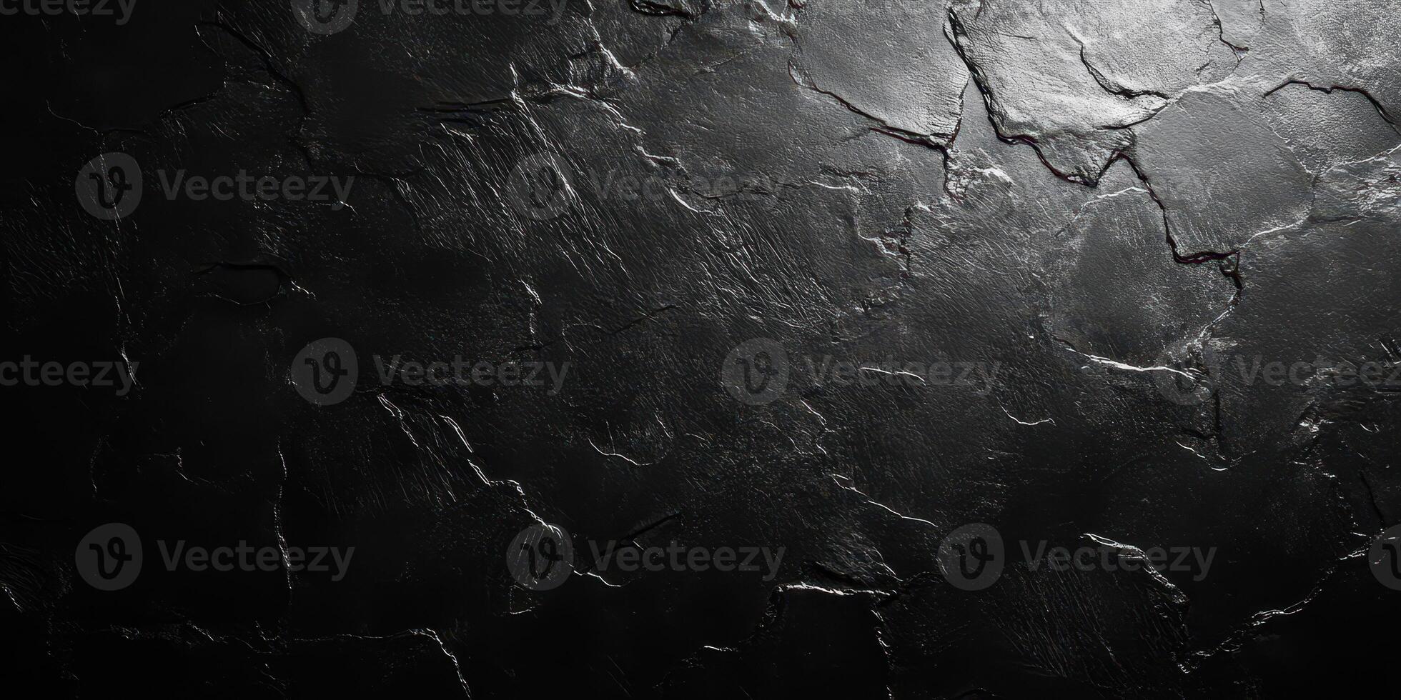 Distinctive black textured surface showcasing natural cracks and uneven patterns in a dramatic lighting setup photo