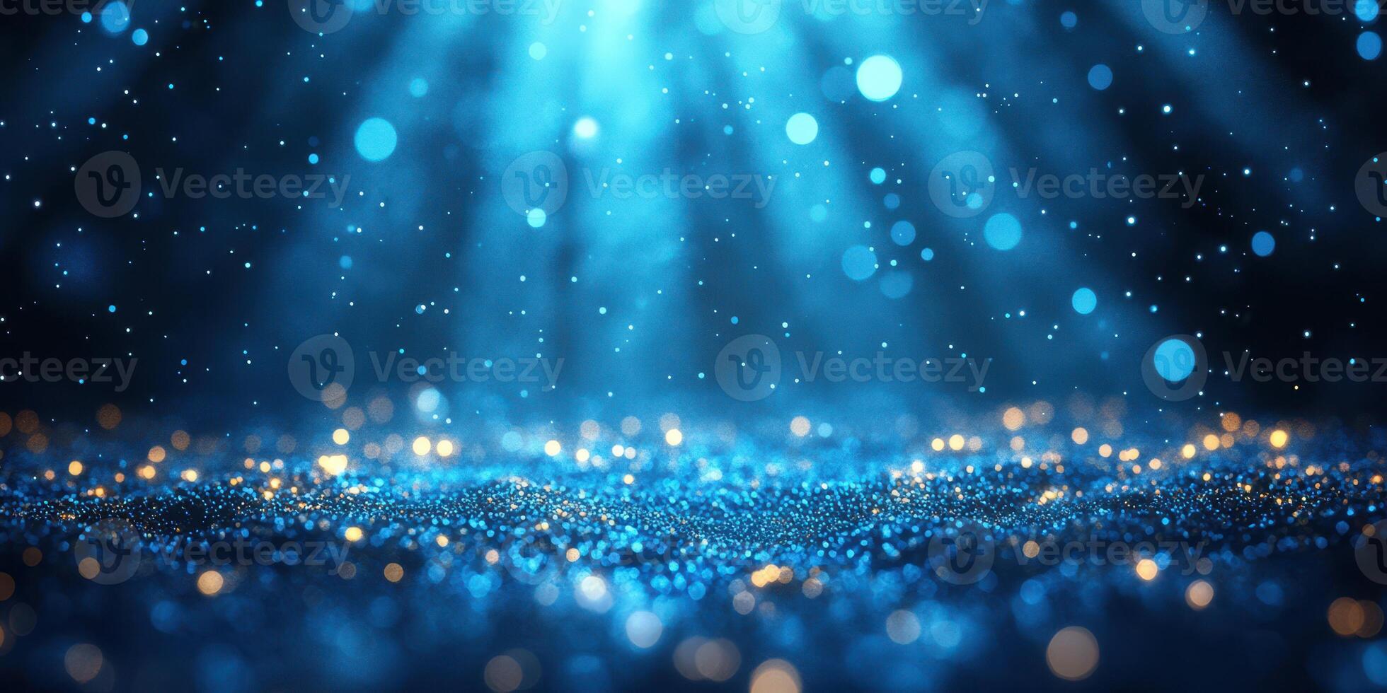 Captivating blue glitter particles illuminated by soft light create a dreamy atmosphere in a dark setting photo