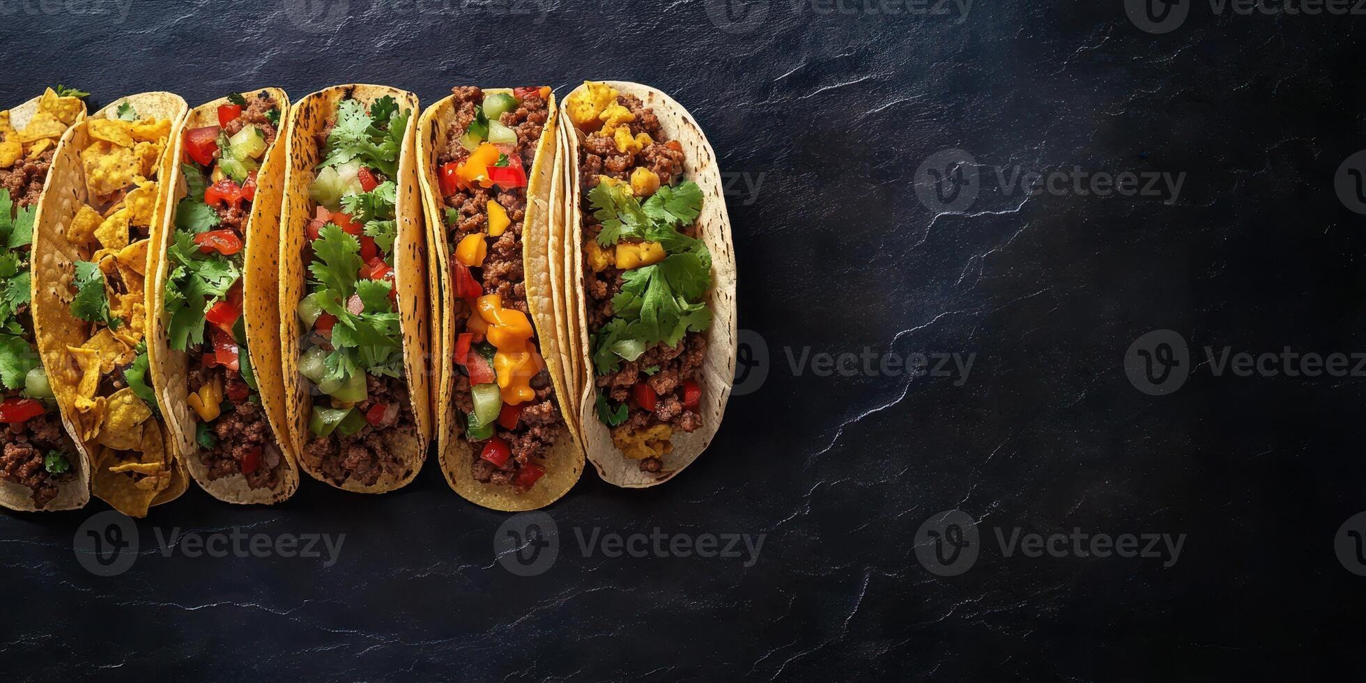 Deliciously arranged variety of flavorful tacos on a dark stone surface appealing to food lovers and enthusiasts photo