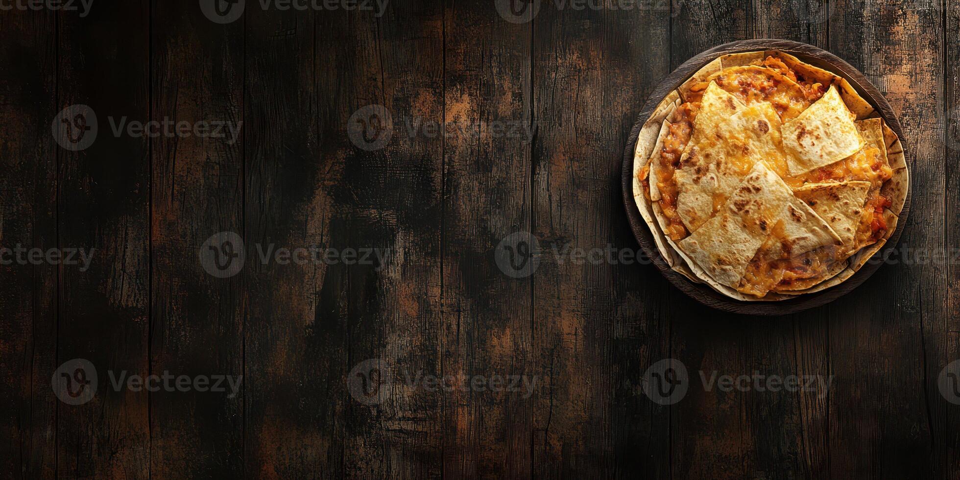 Tasty golden fried quesadillas served on a dark wooden table ready to be enjoyed photo
