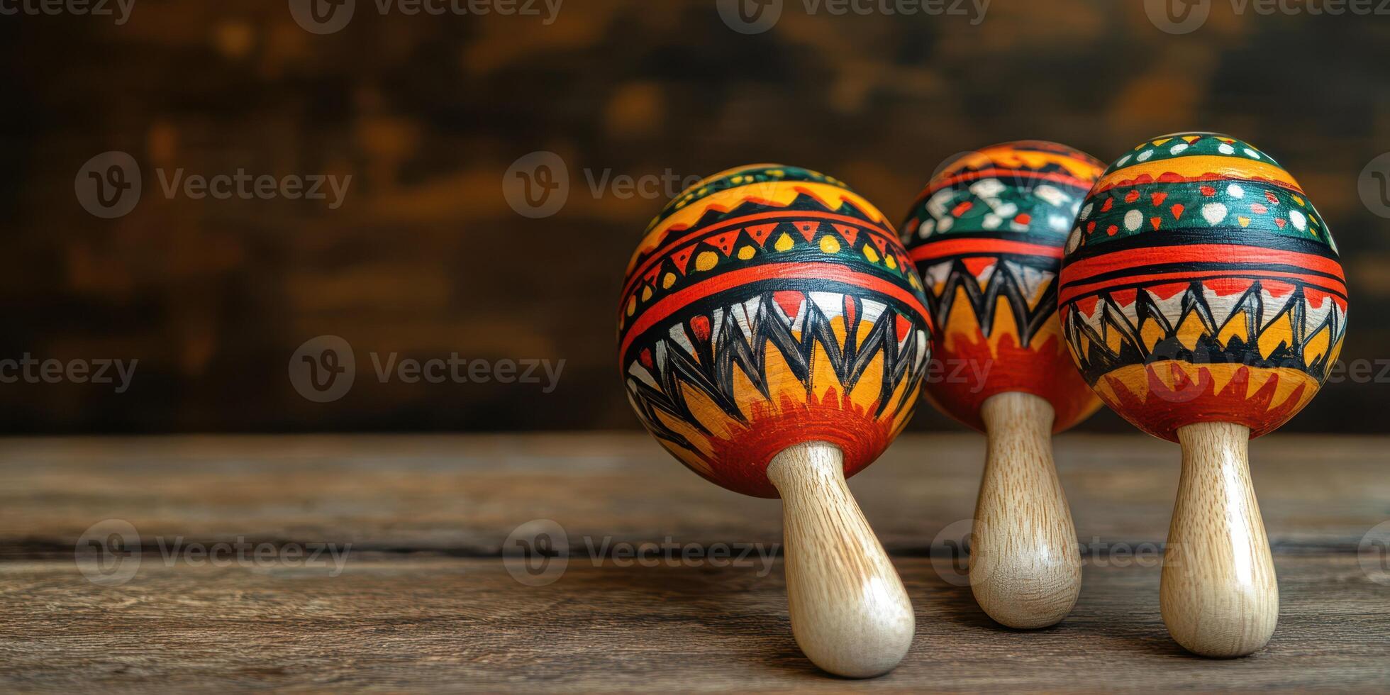 Colorful wooden maracas with intricate designs on a rustic wooden surface in a creative setting photo