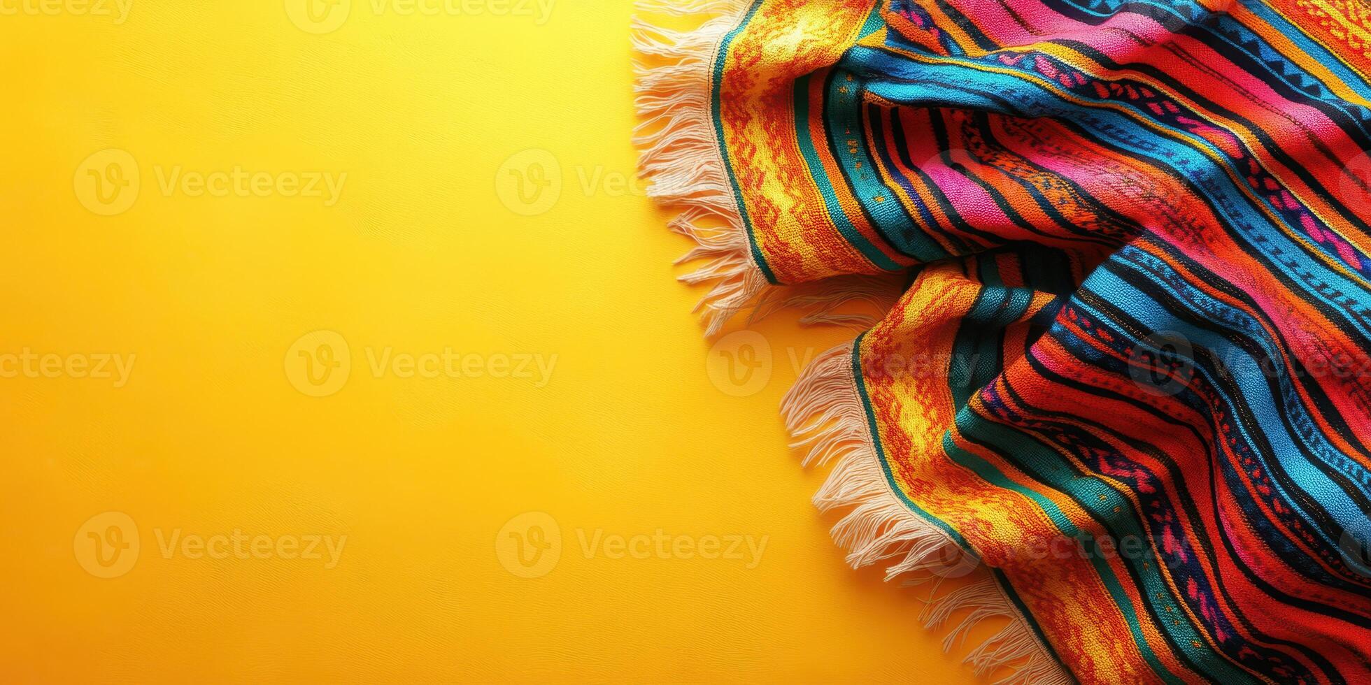 Colorful woven blanket draped on a bright yellow background in a cozy interior setting photo