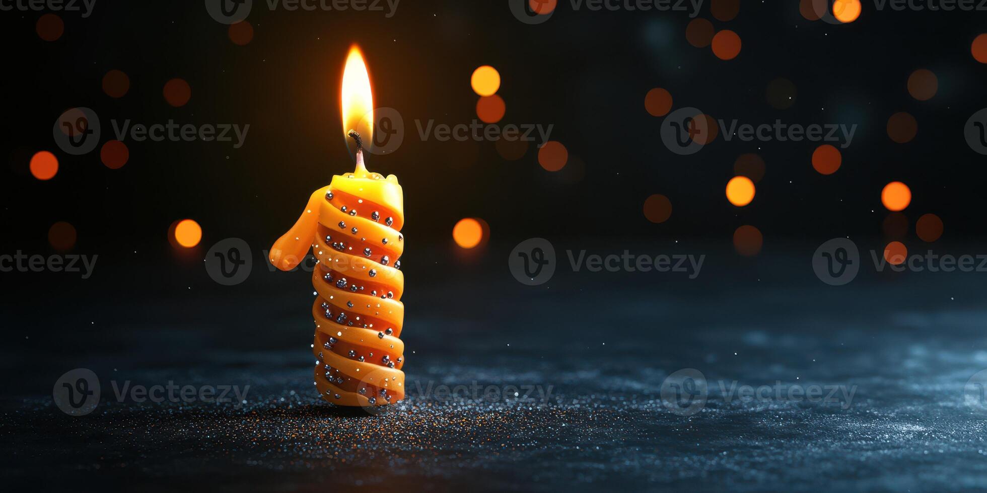 Brightly lit number one candle celebrating a birthday with sparkles on a dark background photo