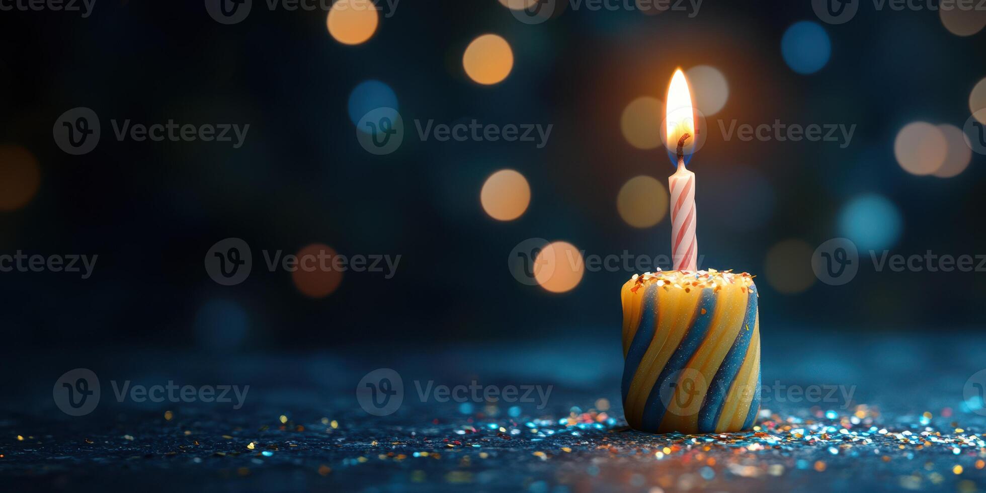 Colorful birthday candle burns brightly on festive table surrounded by sparkling lights photo