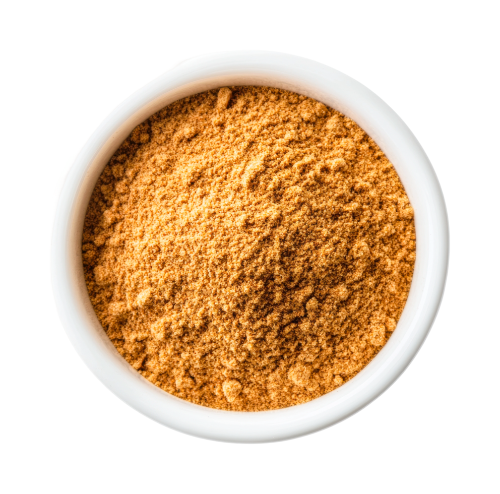 Top view of ground cinnamon spice in a white bowl, cut out png