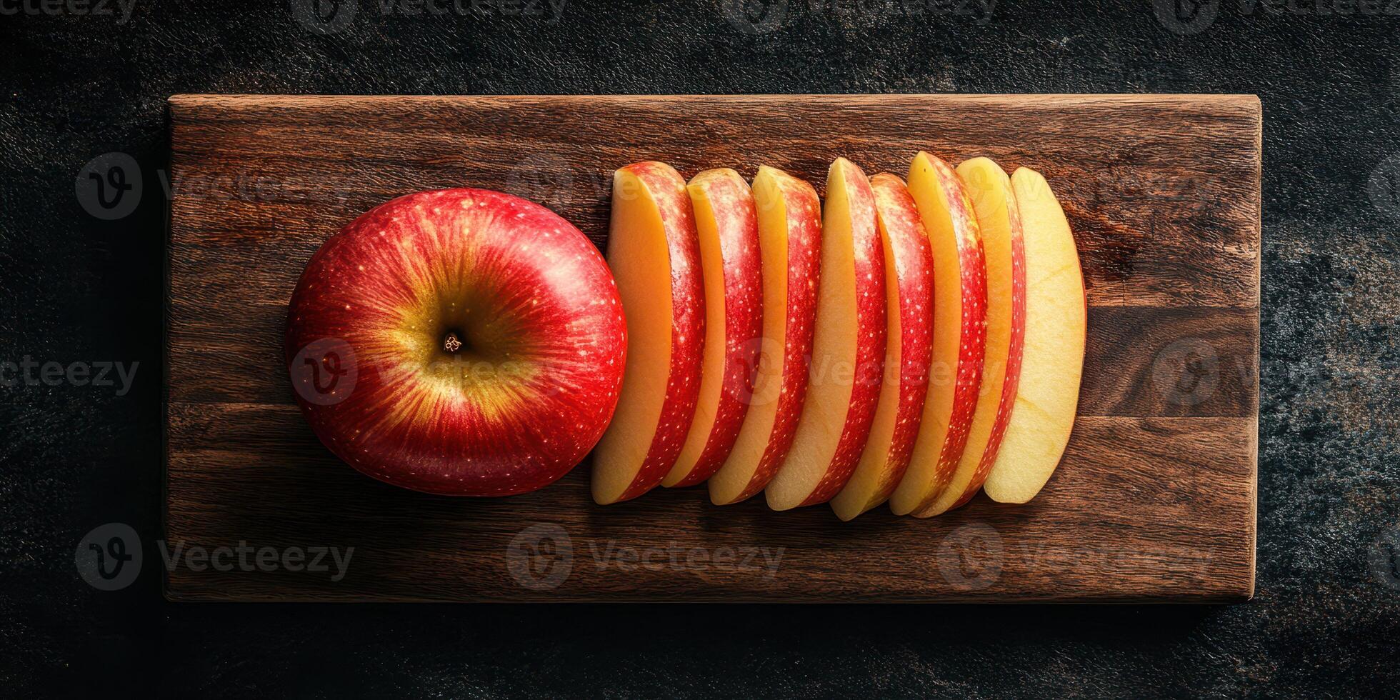 Sliced red apple on wooden cutting board showcasing vibrant colors and freshness photo