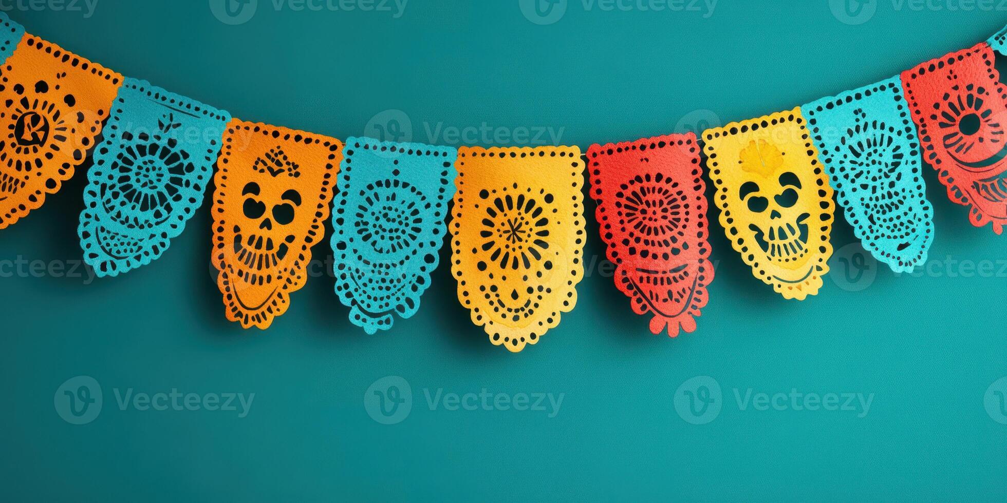 Colorful papel picado decorations hanging against a teal wall for a festive celebration photo
