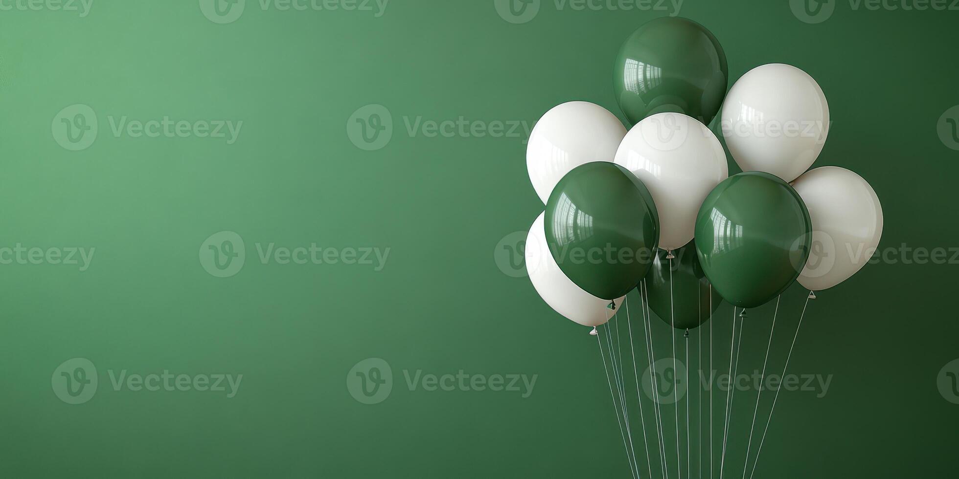 Balloons in varying shades of green and white arranged against a deep green backdrop for a celebration or event photo