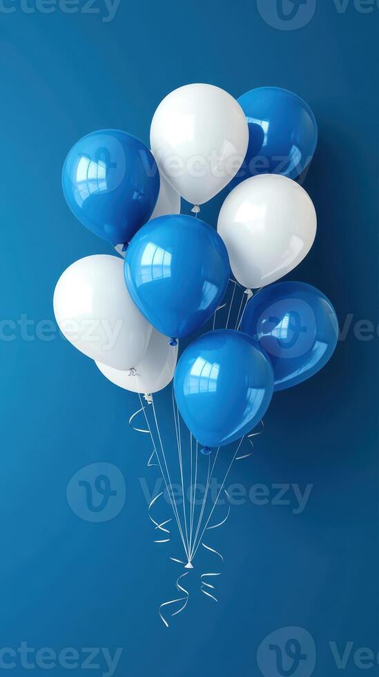 Colorful collection of blue and white balloons floating against a deep blue background photo