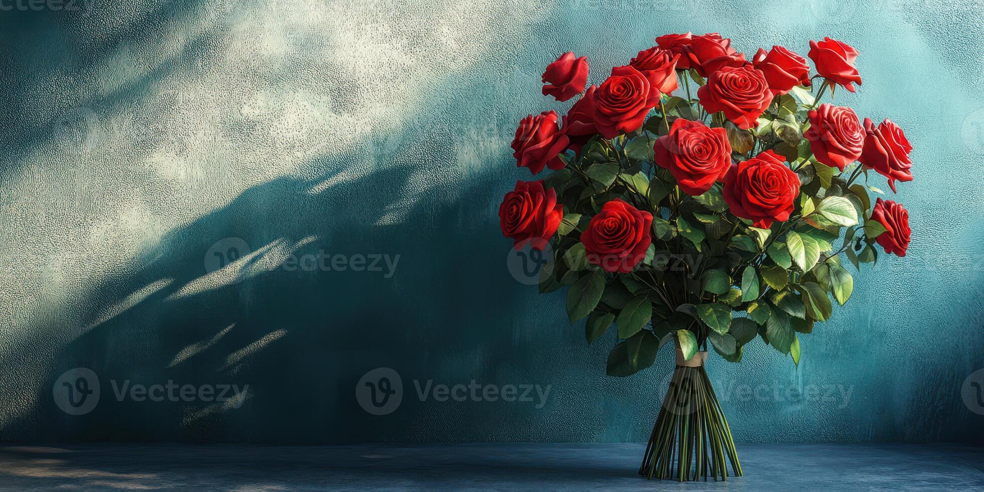 Bouquet of red roses displayed against a textured blue wall in soft light, highlighting their vibrant color and delicate petals photo