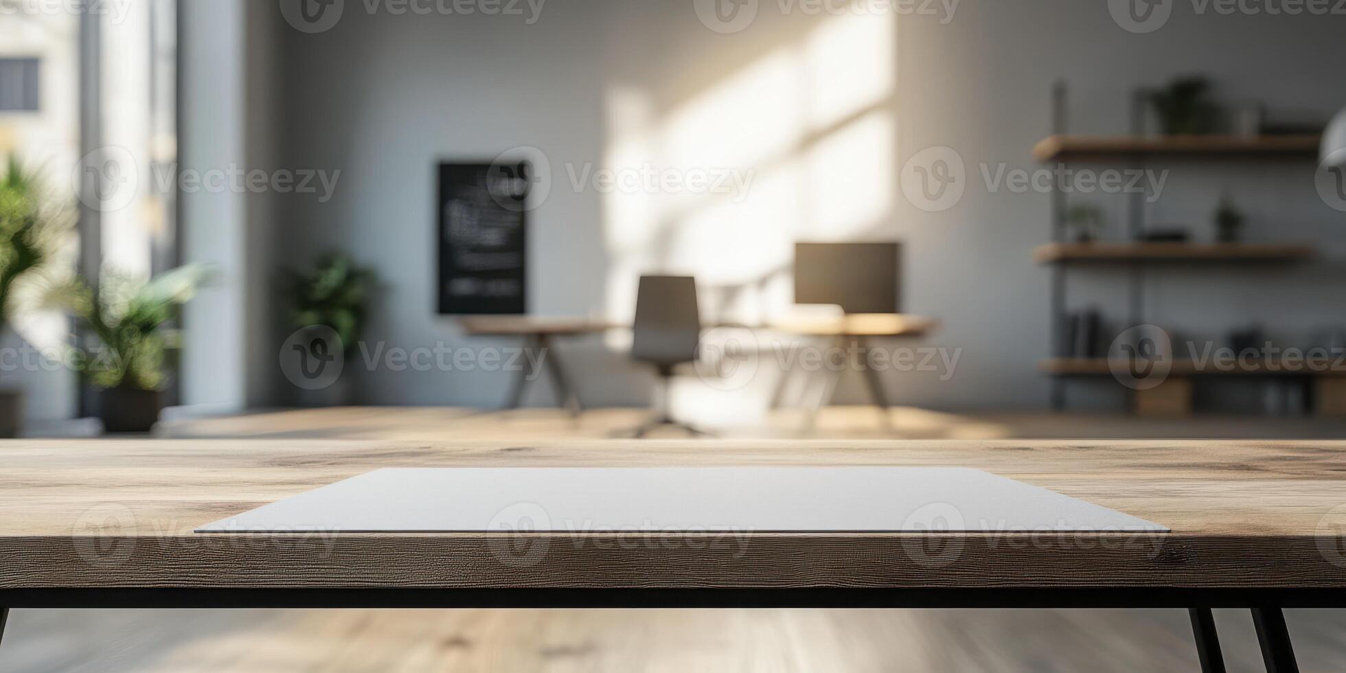 Workspace with a wooden table and sunlight filtering through large windows in a modern office environment photo