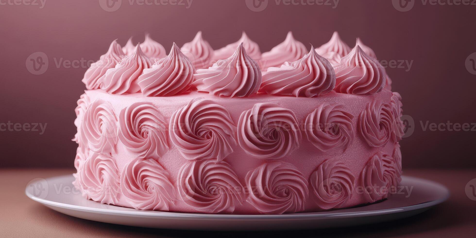 Beautiful pink frosted cake with elegant swirl decoration on a simple plate set against a muted background photo