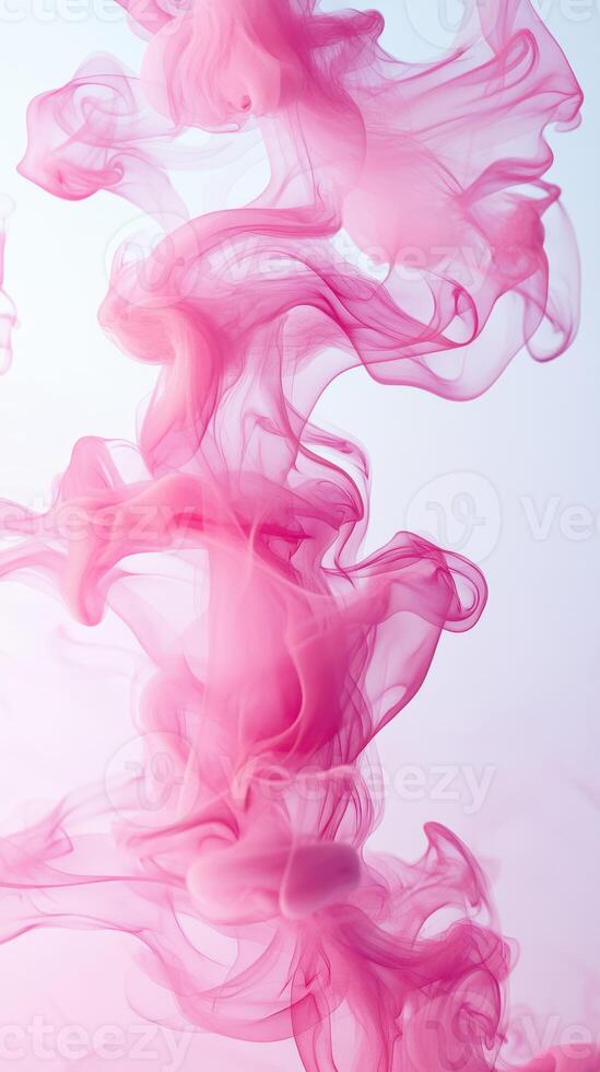 Colorful swirling pink smoke rising against a white backdrop in an abstract display of movement and texture photo