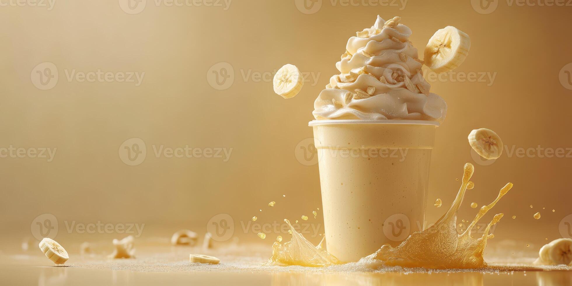 Delicious banana-flavored creamy dessert served in a cup with banana slices and caramel drizzle on a golden background photo