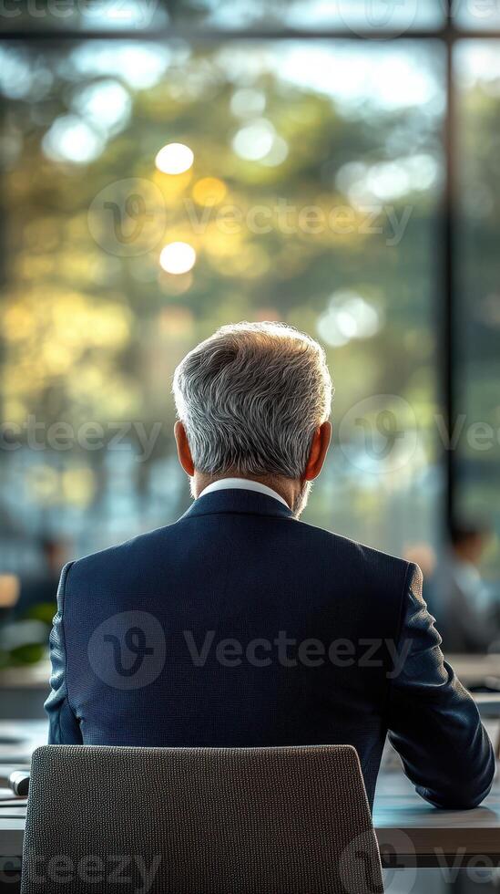 Business meeting taking place in a modern office with a view of nature in the background during daytime hours photo