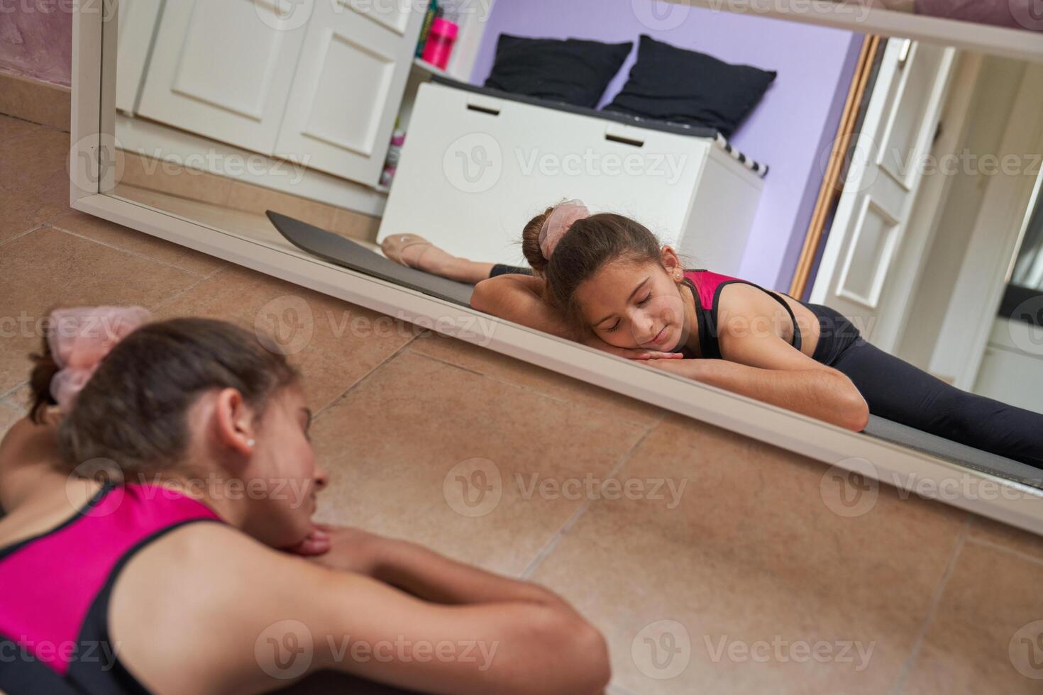 Kid sleeping while doing splits at home photo