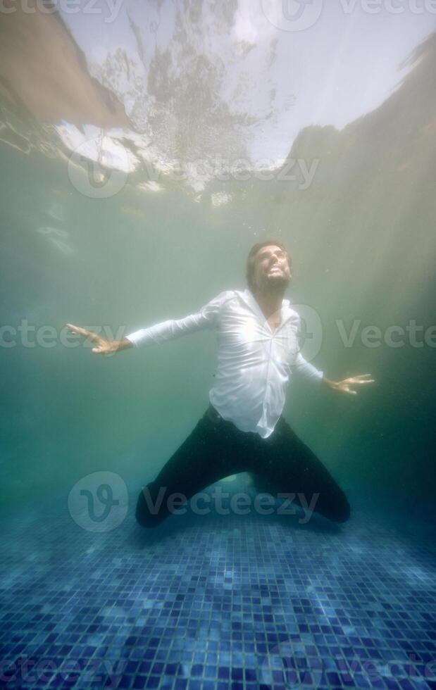 Hopeless man drowning in pool photo