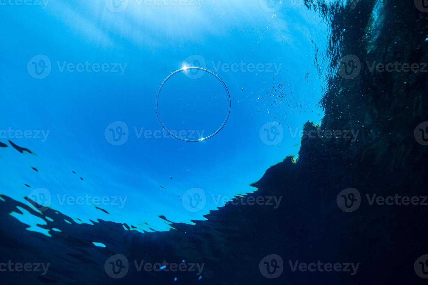 Vortex ring floating under sea water in daylight photo