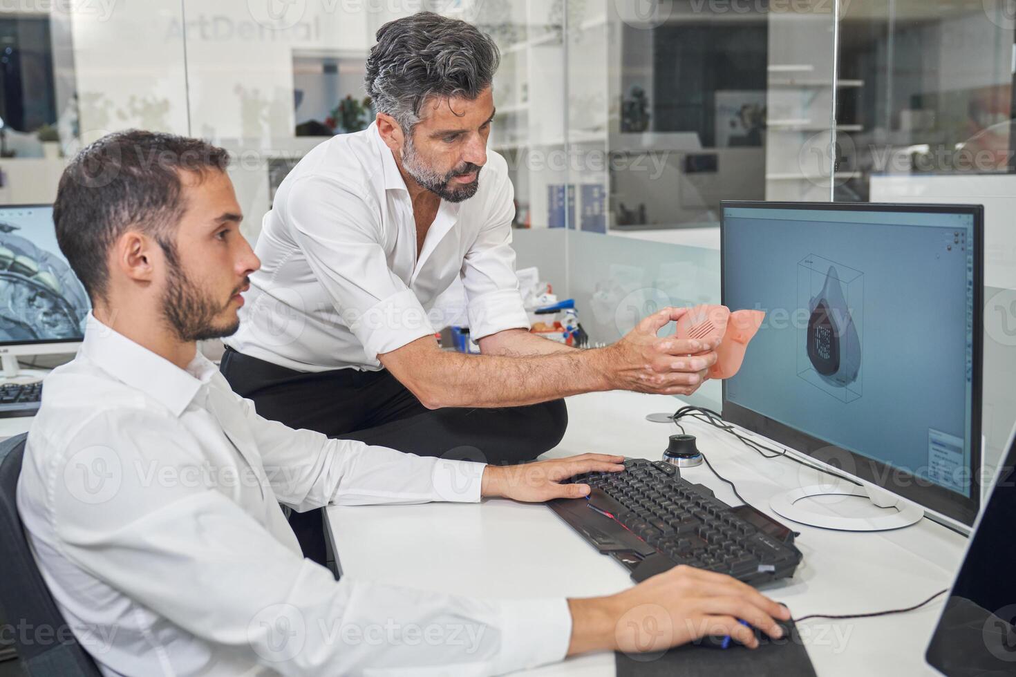 Workers checking 3D respirator near computer photo