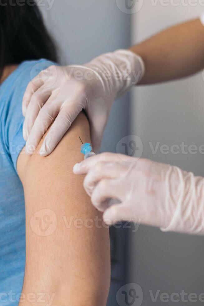 Nurse giving a vaccine to a patient photo