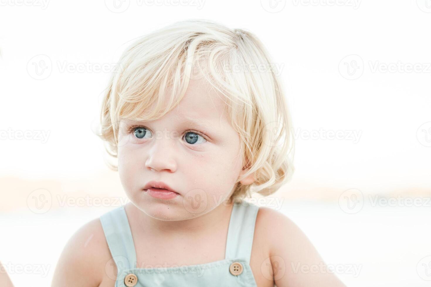 Adorable kid resting at beach photo