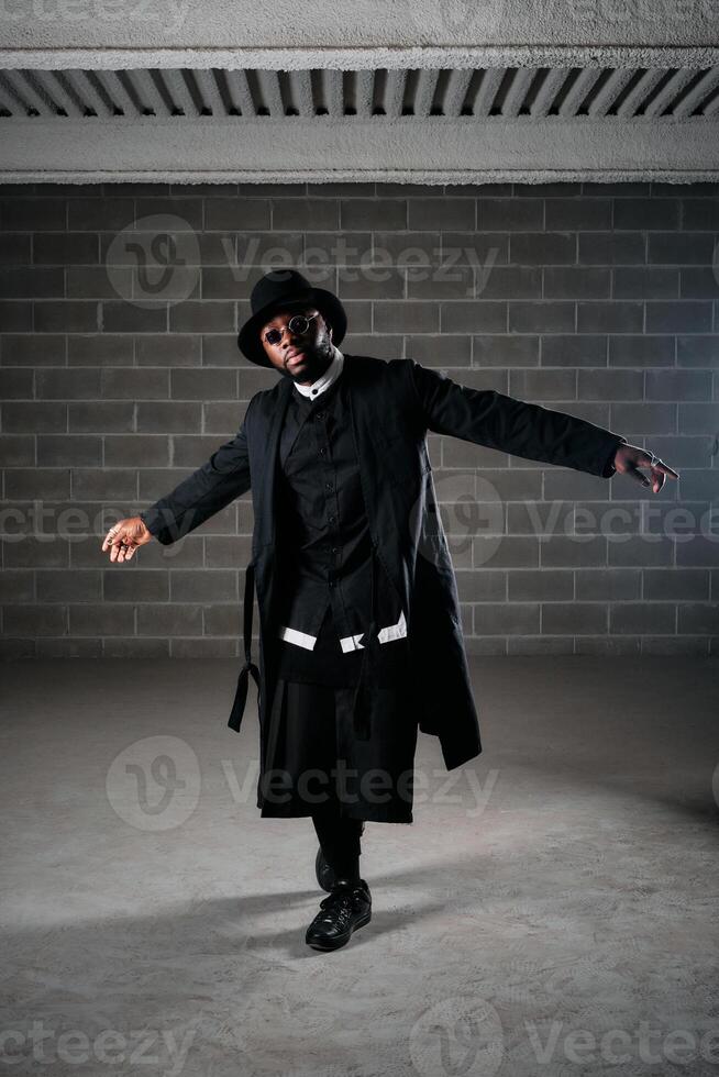Stylish male in trendy clothes with arms apart photo