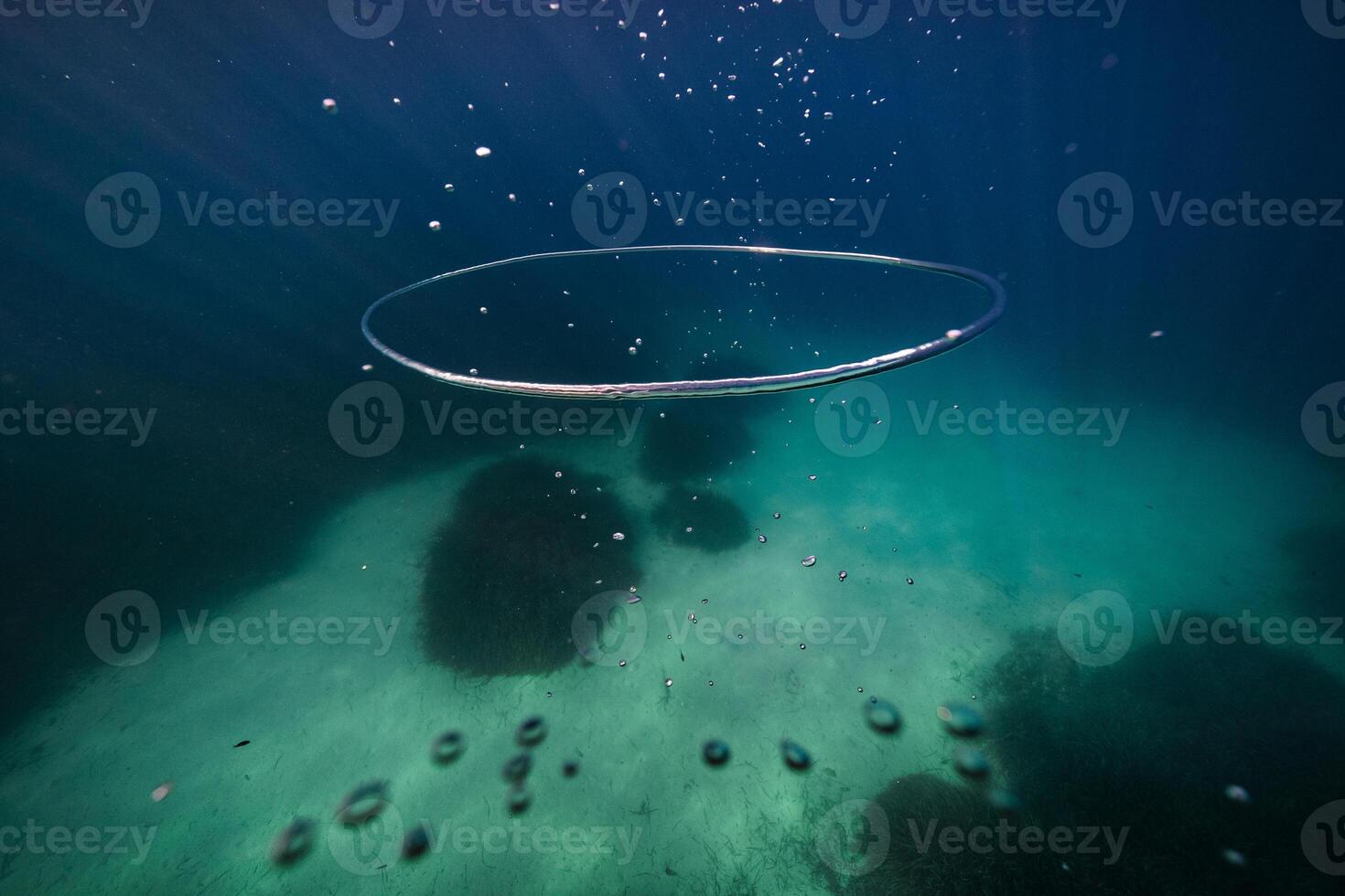 Vortex ring in clear water of deep ocean in daylight photo
