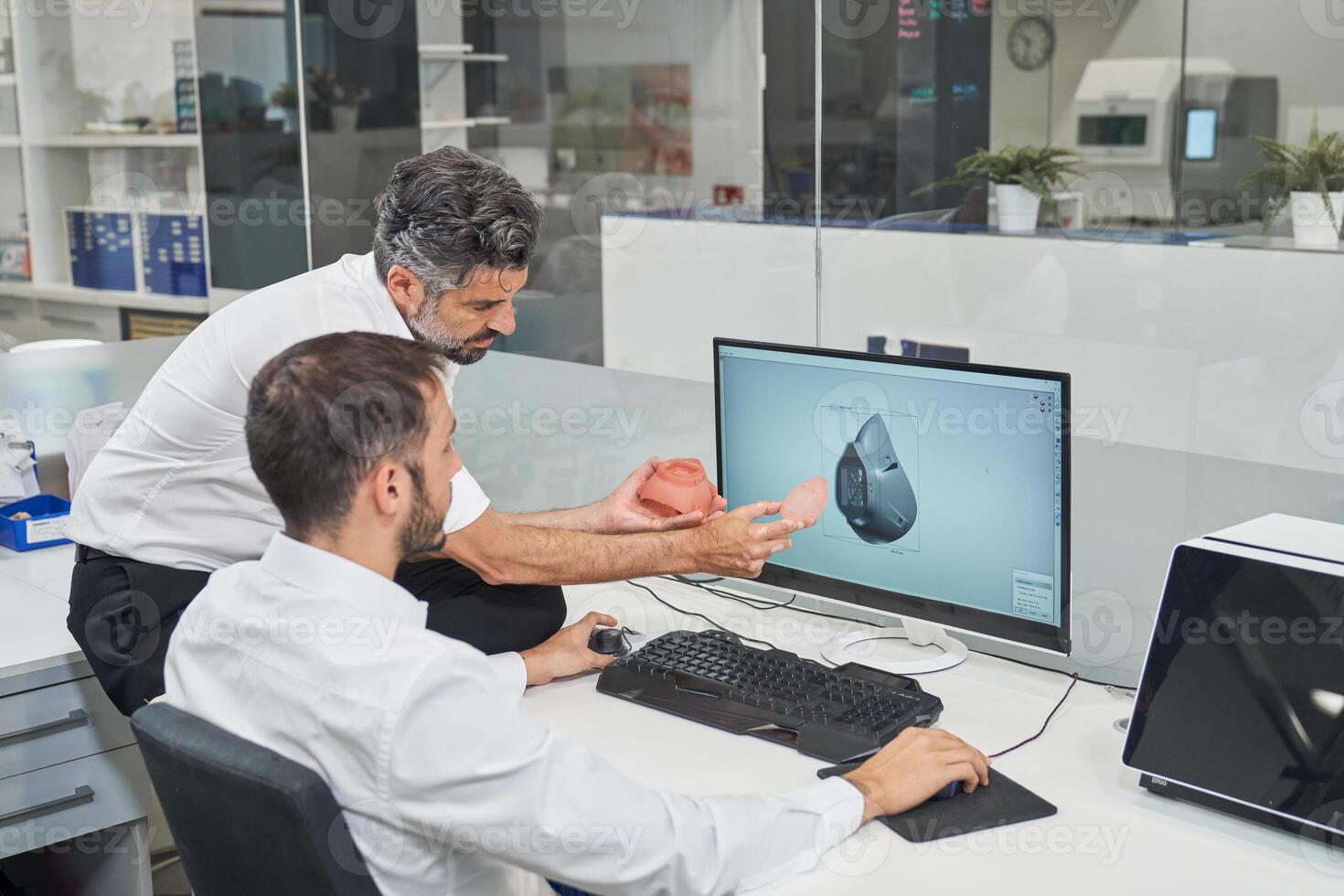 Engineers designing respirator on computer photo