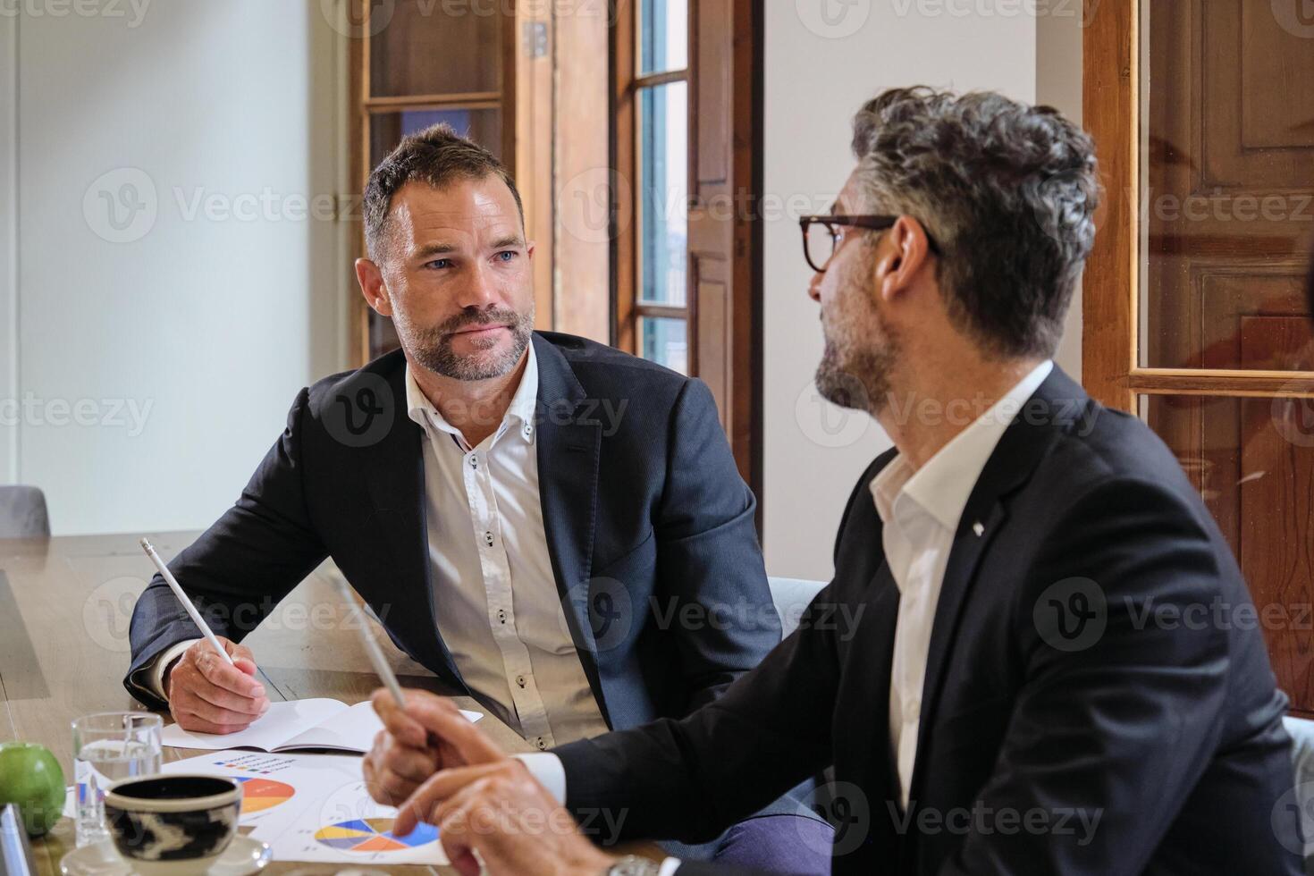 Colleagues looking to each other in office photo
