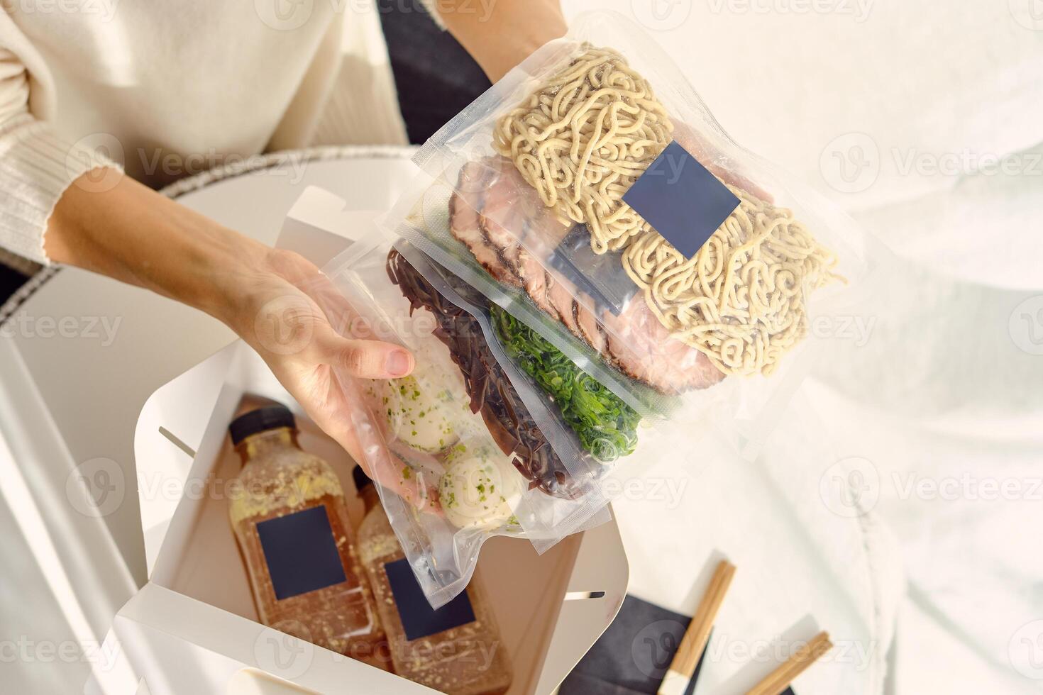 Crop faceless person demonstrating food in vacuum bags photo