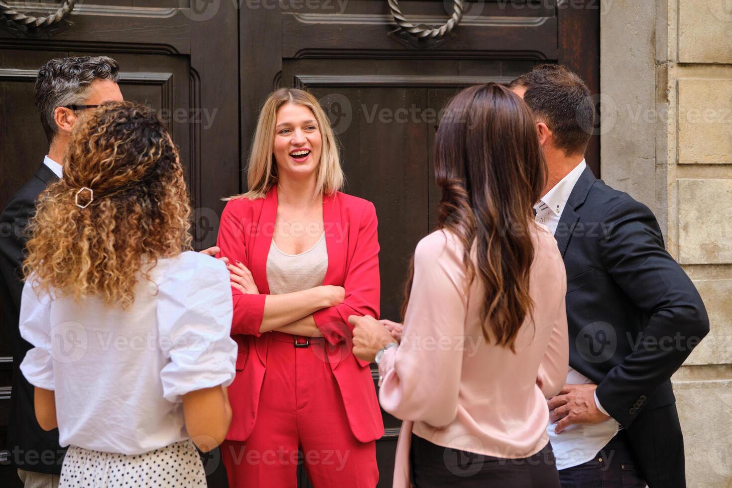 Group of colleagues gathering near wooden door photo